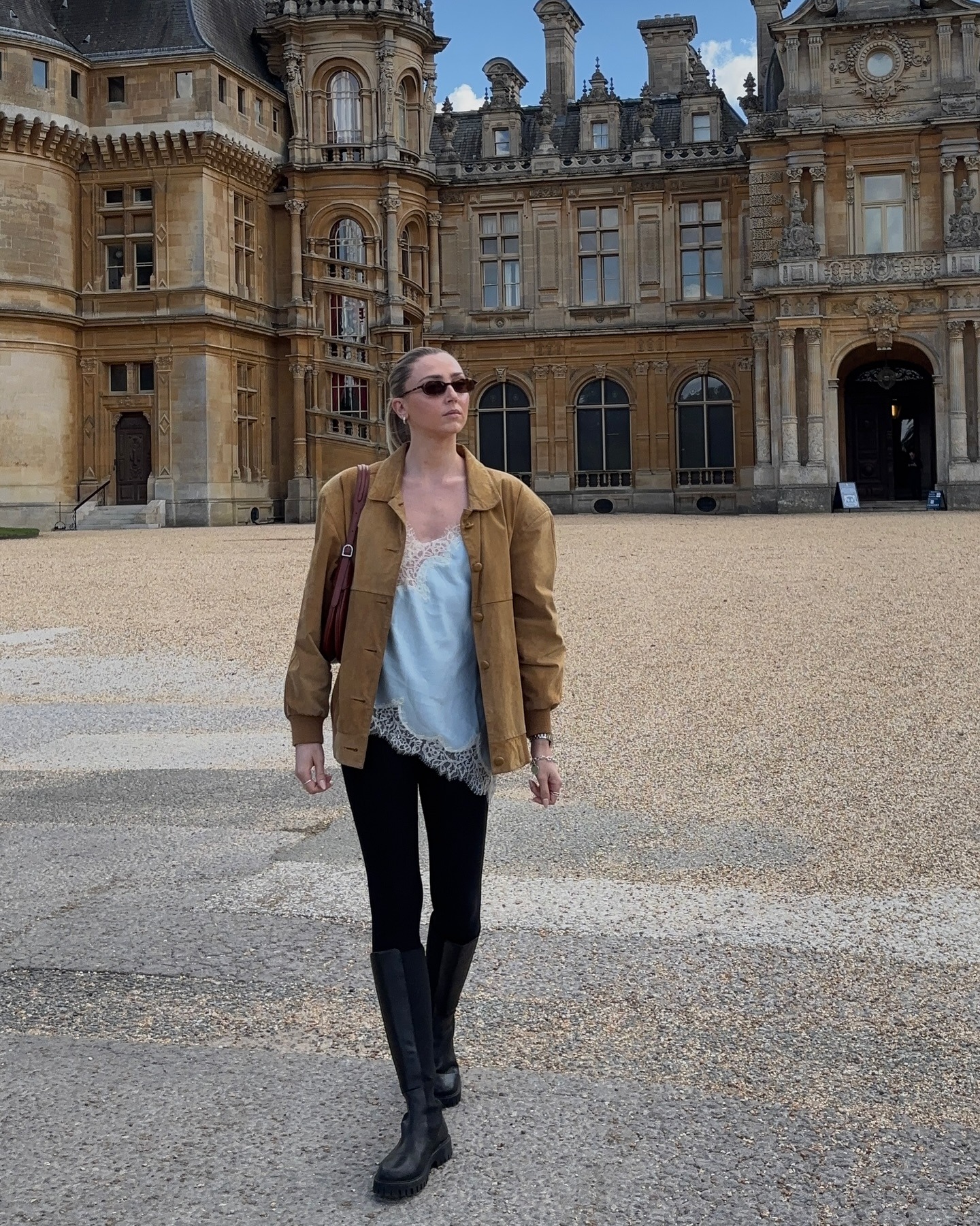 Fashion person Louisa Northcote provides her influencer autumn wish list. She wears a lace trim blue cami, suede jacket, black legging and knee high boots in a recent image taken from her Instagram.