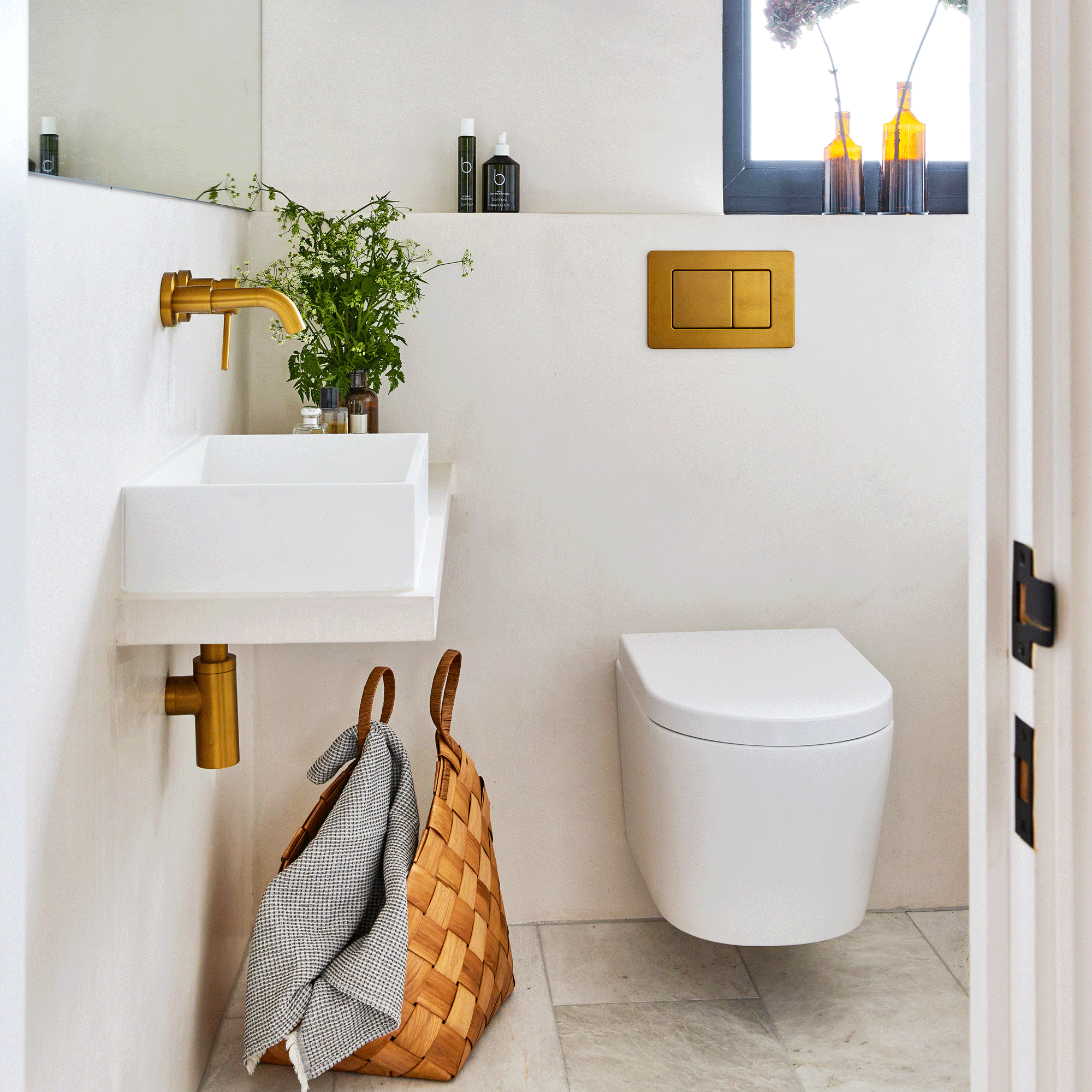 a contemporary bathroom with a wall hung basin and toilet