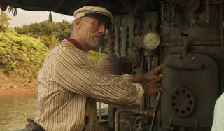 Dwayne Johnson guards the stove to the ship in Jungle Cruise.