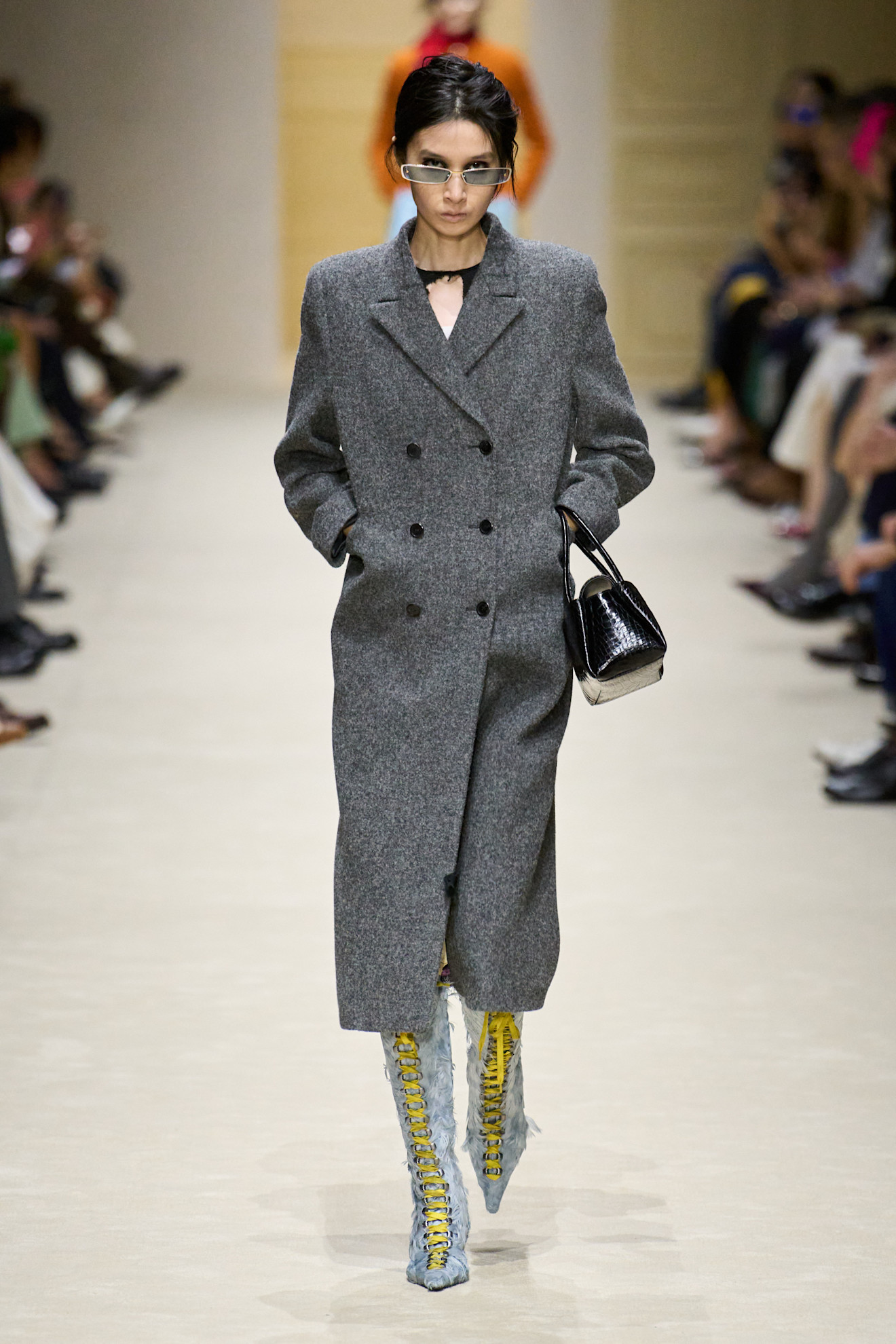 A model at the Prada show wearing blue shoes.