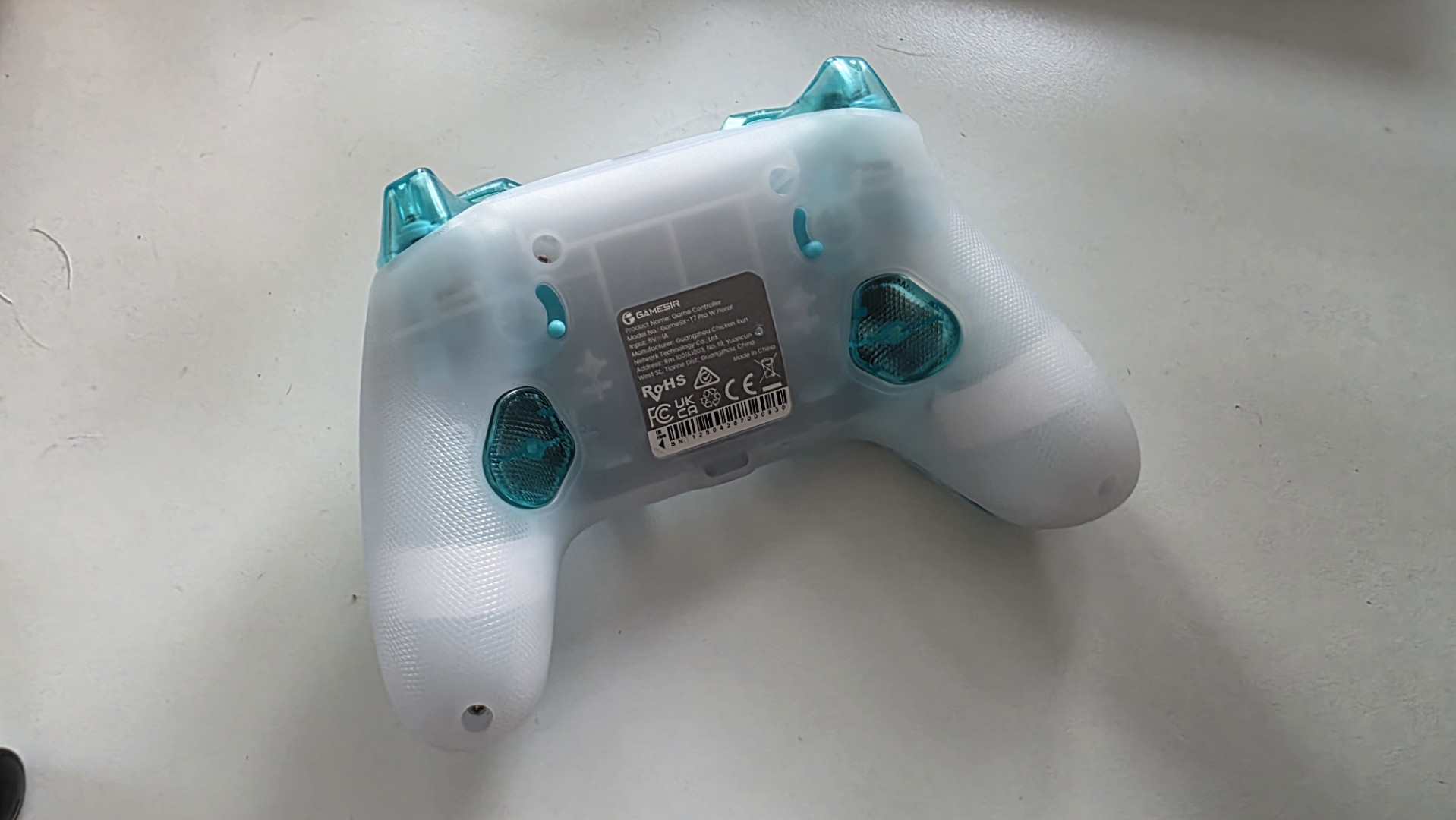 A blue and white controller with floral pattern