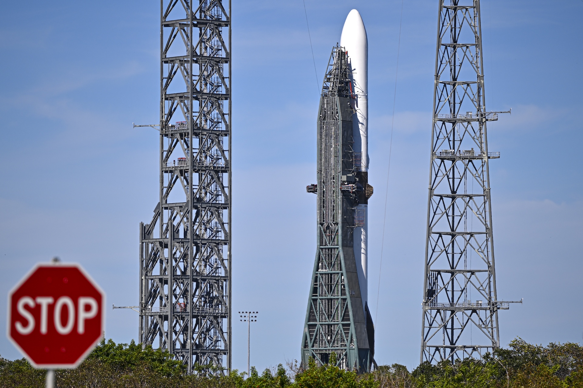 a photo of Blue Origin&#039;s New Glenn rocket with a &quot;stop&quot; sign visible in the foreground