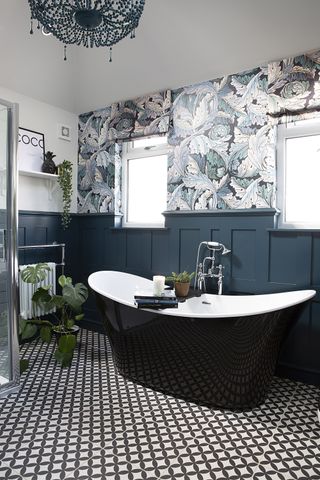 dark elegant bathroom with blue wall panelling and vibrant wallpaper