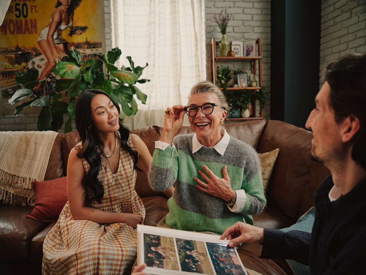 Woman wearing frames with friends looking at photos