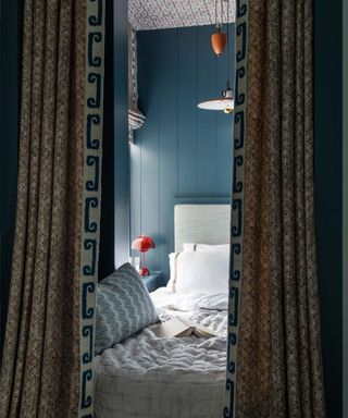 Blue bed nook with curtains in a cozy apartment in West Village, NYC