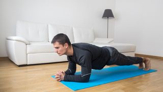A man performing a plank during a home workout