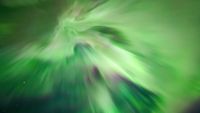 aurora overhead known as a corona whereby huge green curtains of light stretch down from the sky during an intense northern lights show.