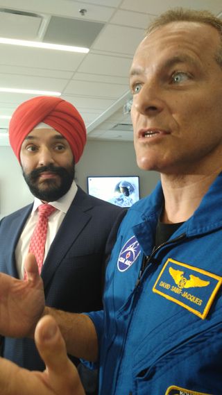 Canadian astronaut David Saint-Jacques (right) speaks with reporters in Ottawa on Oct. 24, 2018, along with Navdeep Bains, Canada's minister of innovation, science and economic development.
