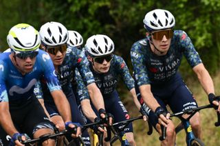 Team Visma - Lease a Bike team's Danish rider Jonas Vingegaard (C) cycles with the pack of riders (peloton) during the 12th stage of the 111th edition of the Tour de France cycling race, 203,6 km between Aurillac and Villeneuve-sur-Lot, southwestern France, on July 11, 2024. (Photo by Marco BERTORELLO / AFP)