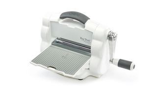 A product image of the Sizzix Big Shot Foldaway embossing machine on a white background
