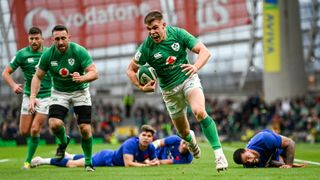 Garry Ringrose of Ireland runs through for a try with French players looking on from the floor in the background