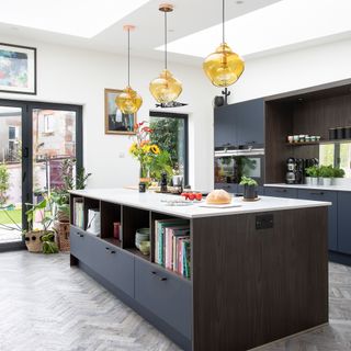 Blue kitchen with island and pendant lighting