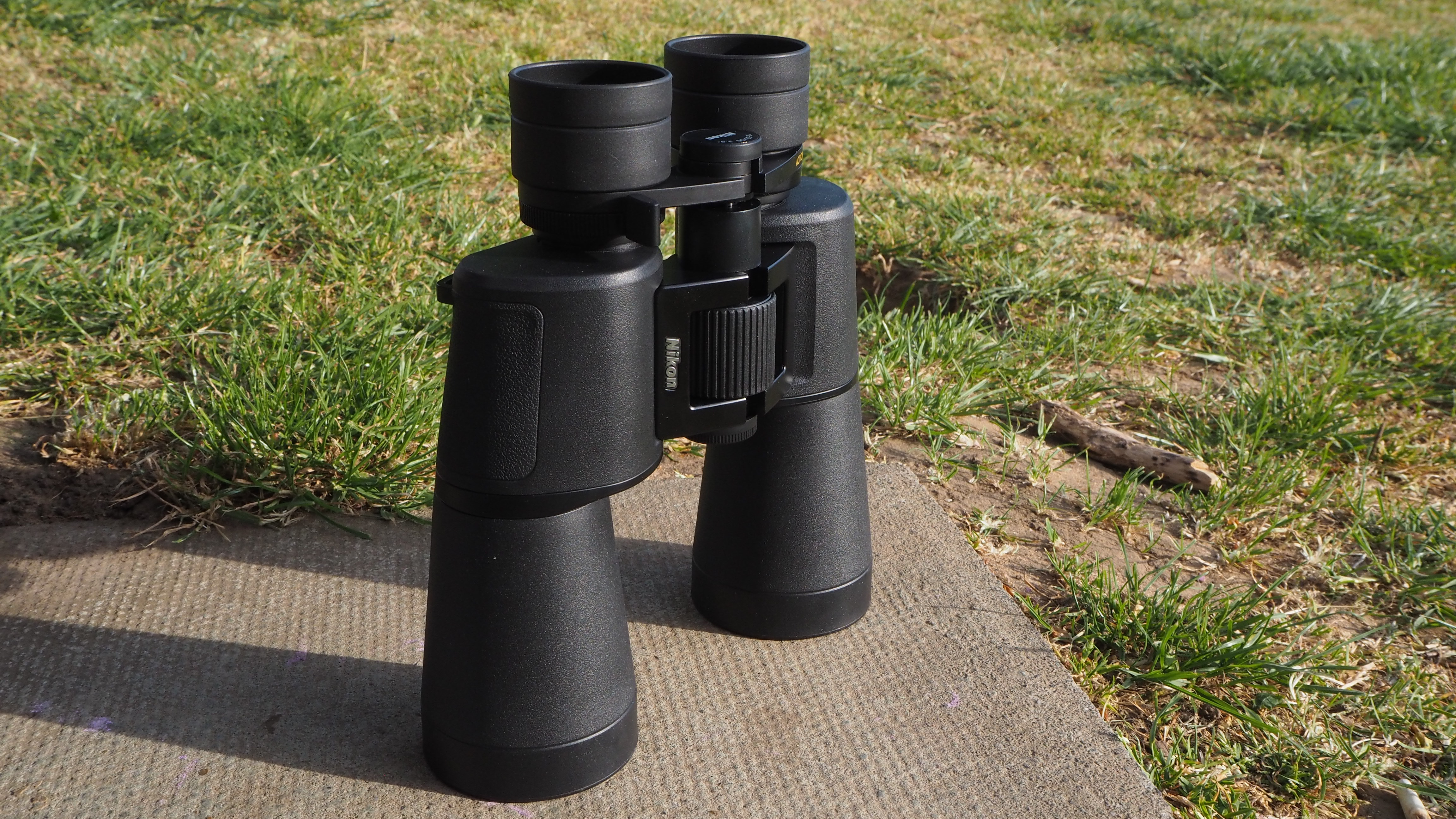 Nikon Action Zoom 10-22x50 binoculars on a paving slab