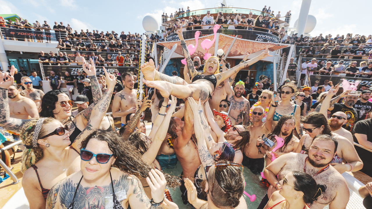 A woman crowdsurfing over people in a pool