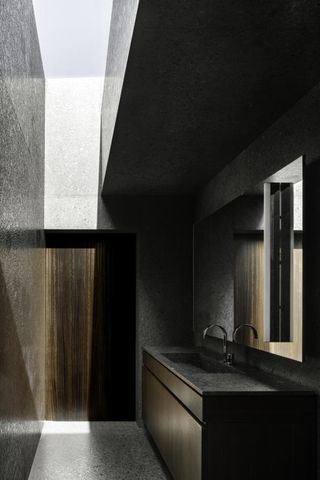 Dark concrete bathroom surface