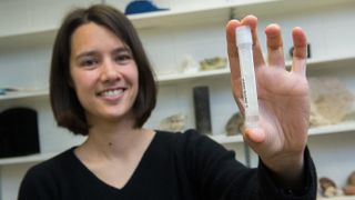 Assistant Professor Clara Blättler with a vial of seawater dating to the last Ice Age—about 20,000 years ago.