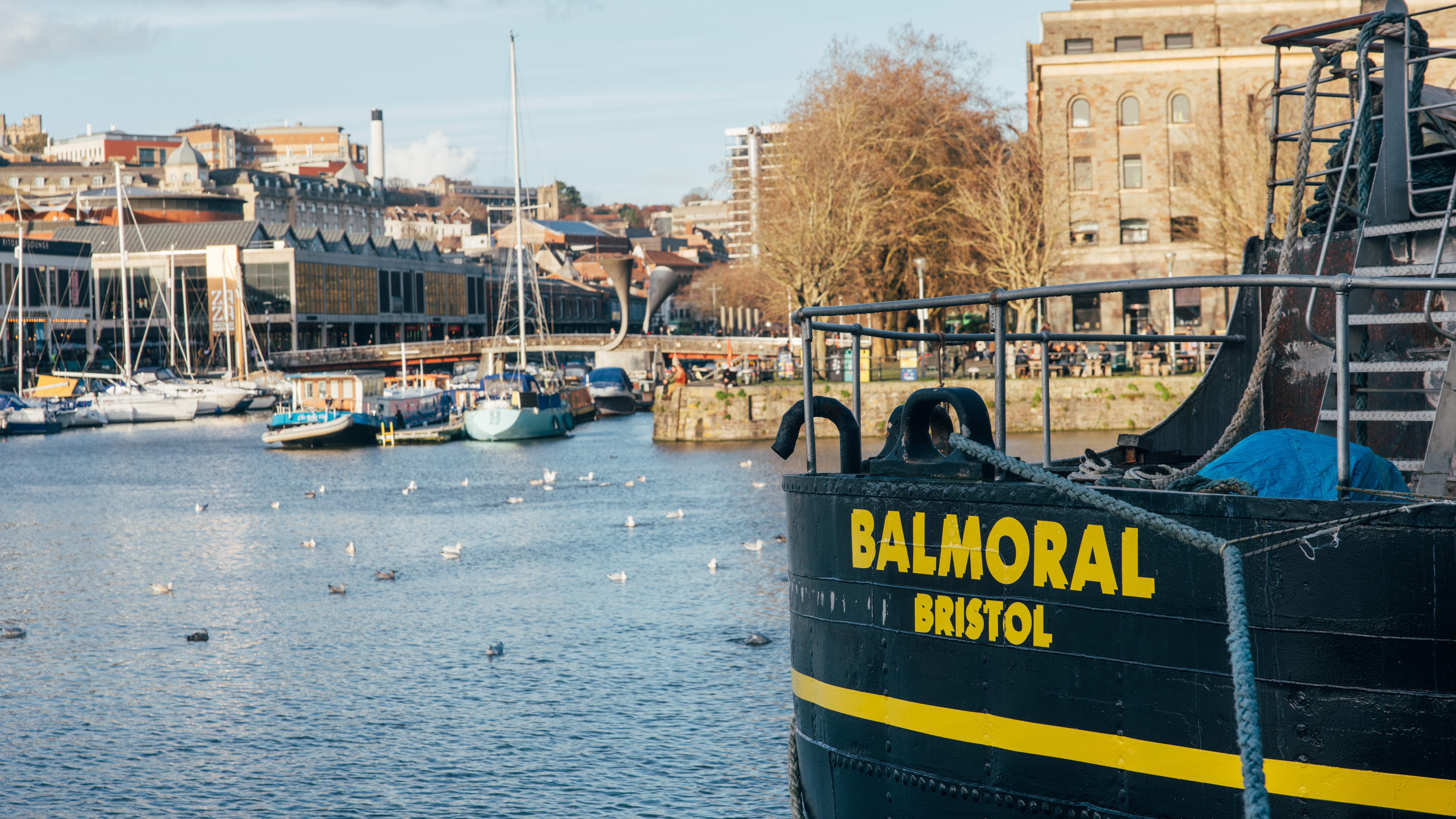 A scene of Bristol Harbour, with a boat in the foreground