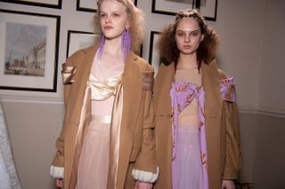 2 Girls in pink dress and light brown jacket