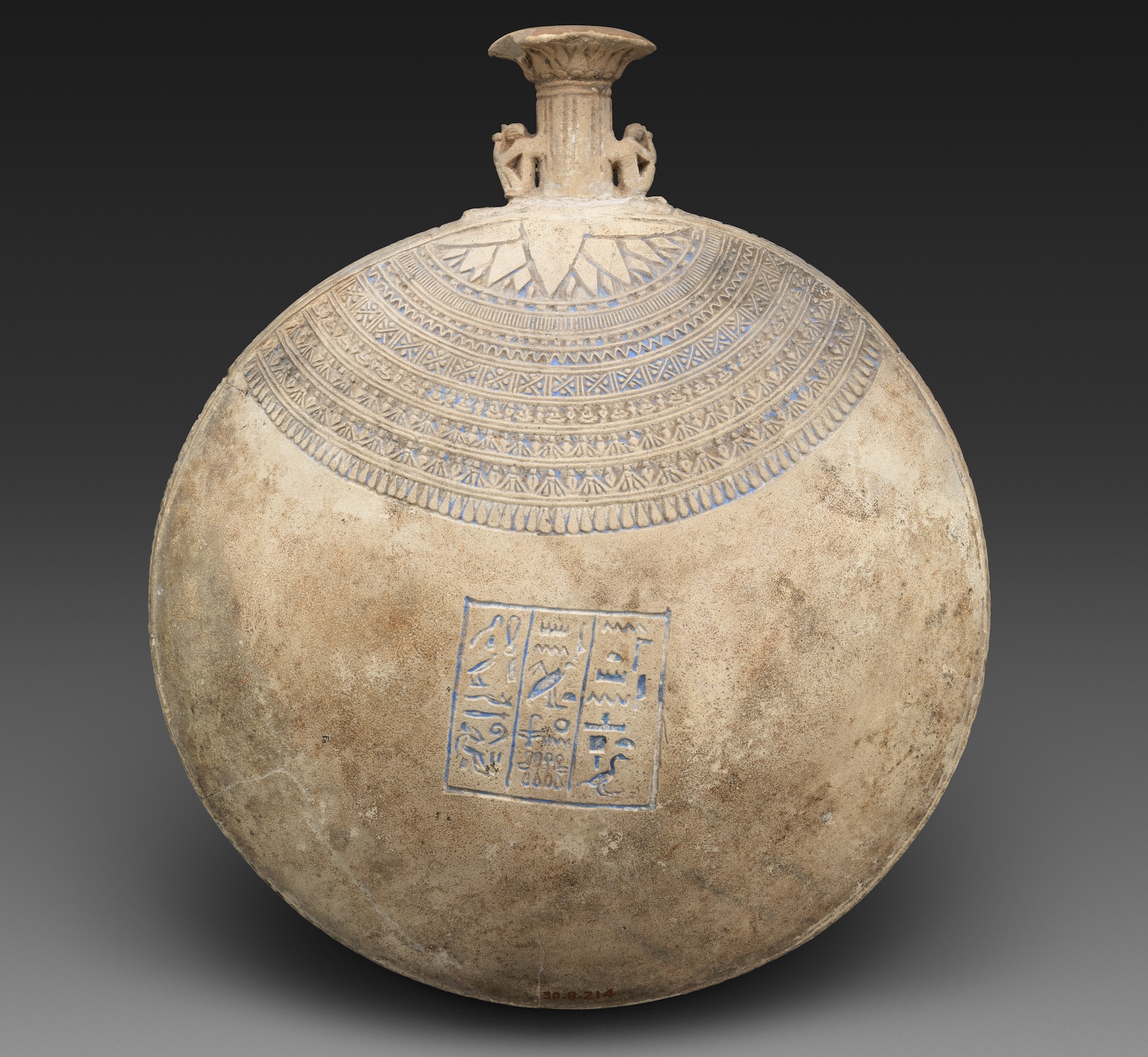 an ancient Egyptian bottle with inscriptions