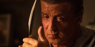 Rambo thinking hard while holding his knife