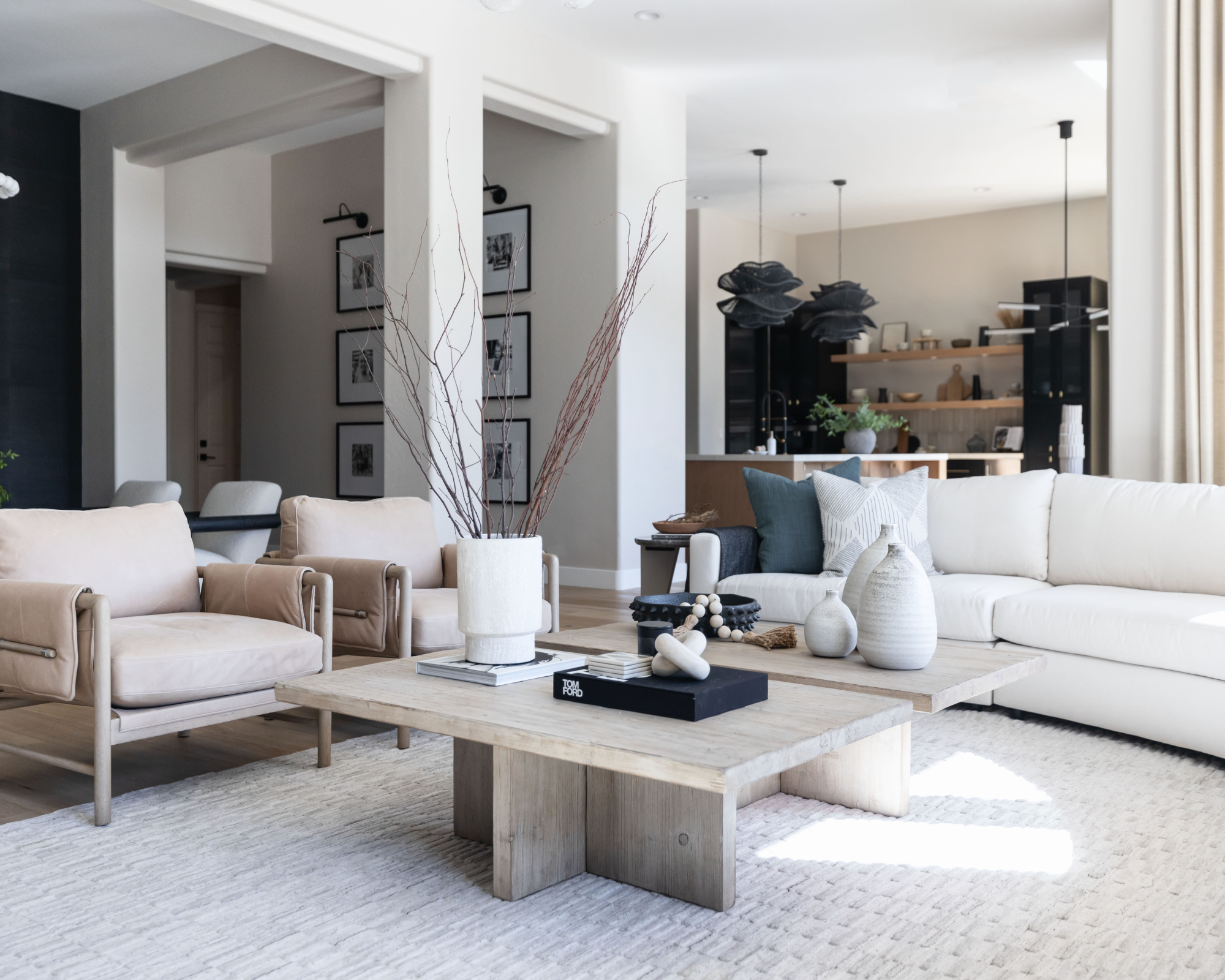Neutral minimal living room with u-shaped couch and two contemporary armchairs creating intimate layout