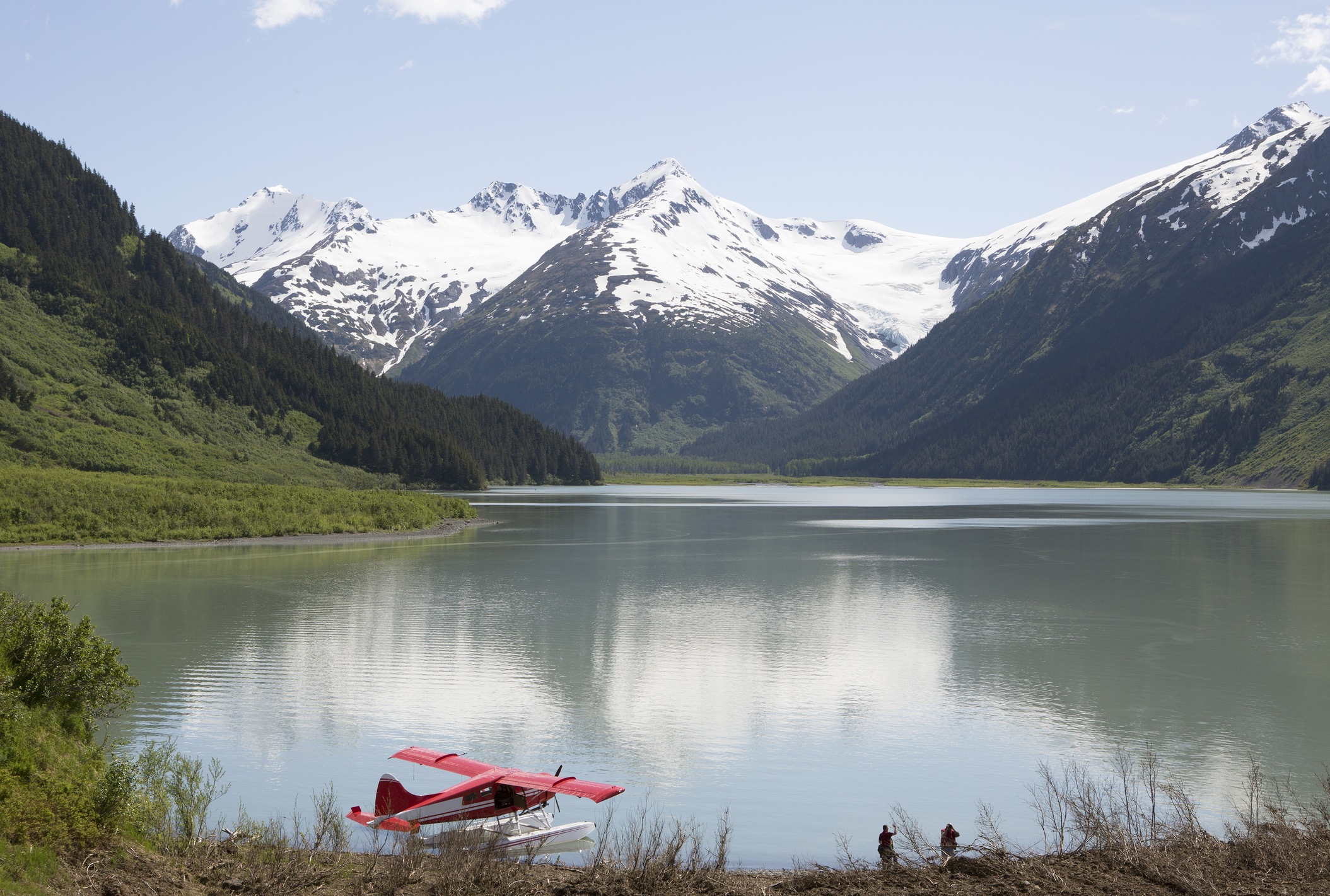 "Seaplane docked in still lake in mountain landscape, Anchorage, Alaska, Denali National Park, United States"