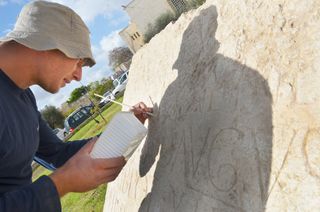 A researcher preserves the nearly 2,000-year-old inscription.