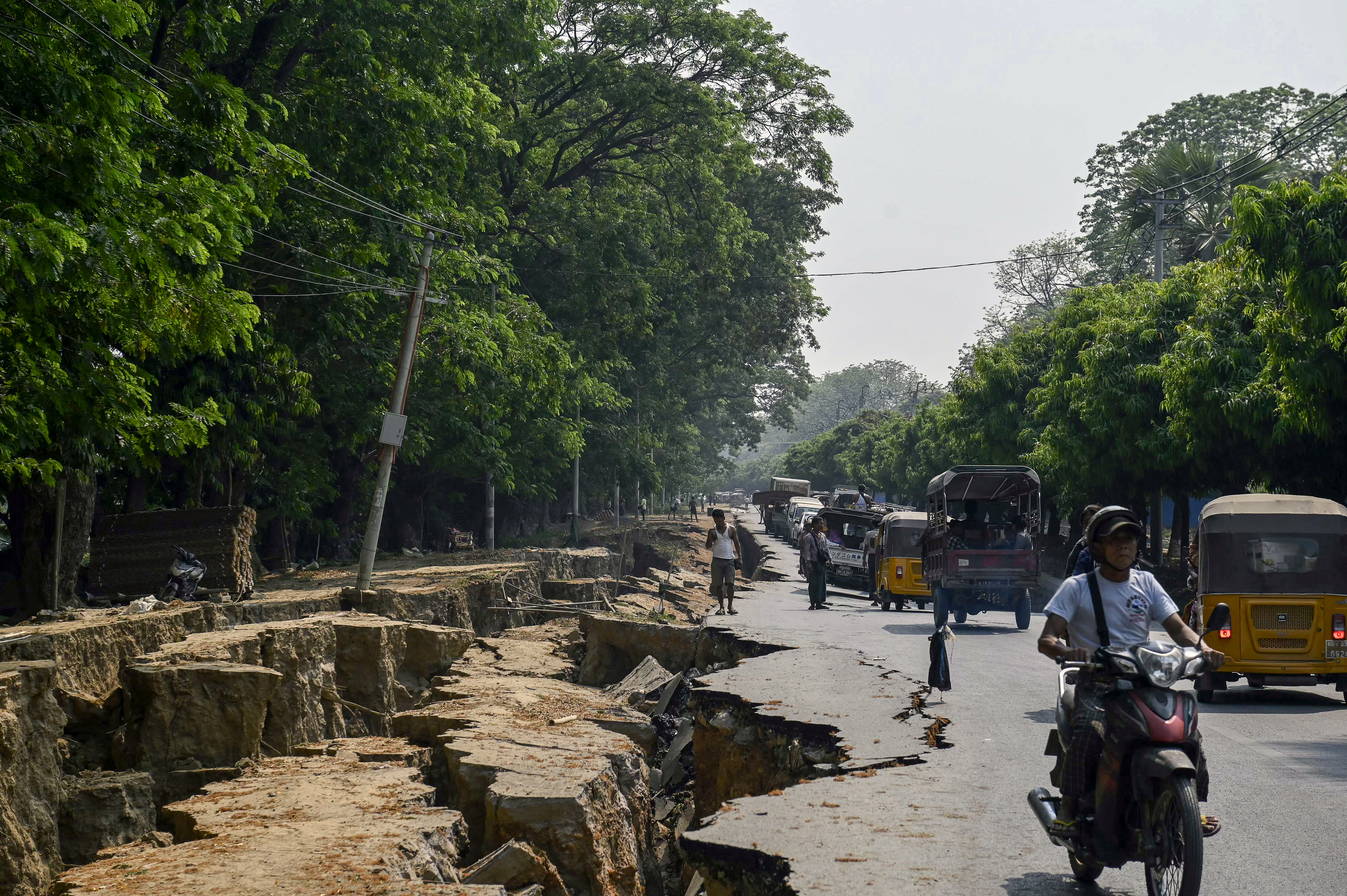 A photograph of the ground ripped open along a road on the outskirts of Mandalay on April 2, 2025, five days after the Myanmar earthquake.