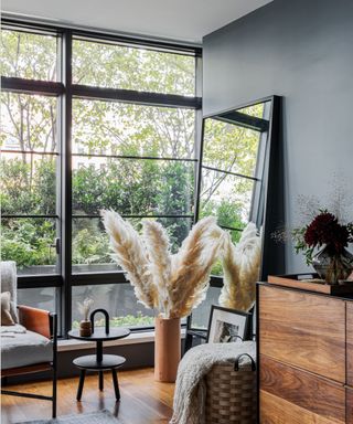 A room with floor-to-ceiling windows and blue walls