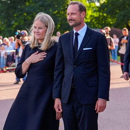 Queen Mette-Marit and King Haakon wearing black outfits 