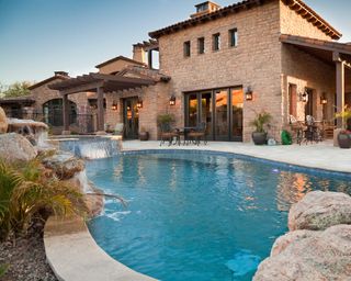 swimming pool with hot tub and waterfall