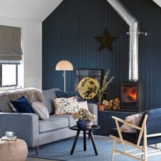 blue living room with sofa and fire place