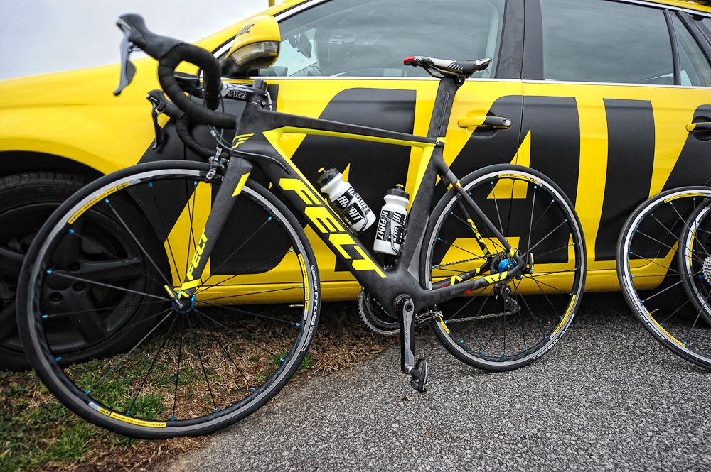 A Felt team bike leans against a Mavic support car.