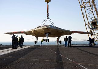X47B Drone Boards Aircraft Carrier