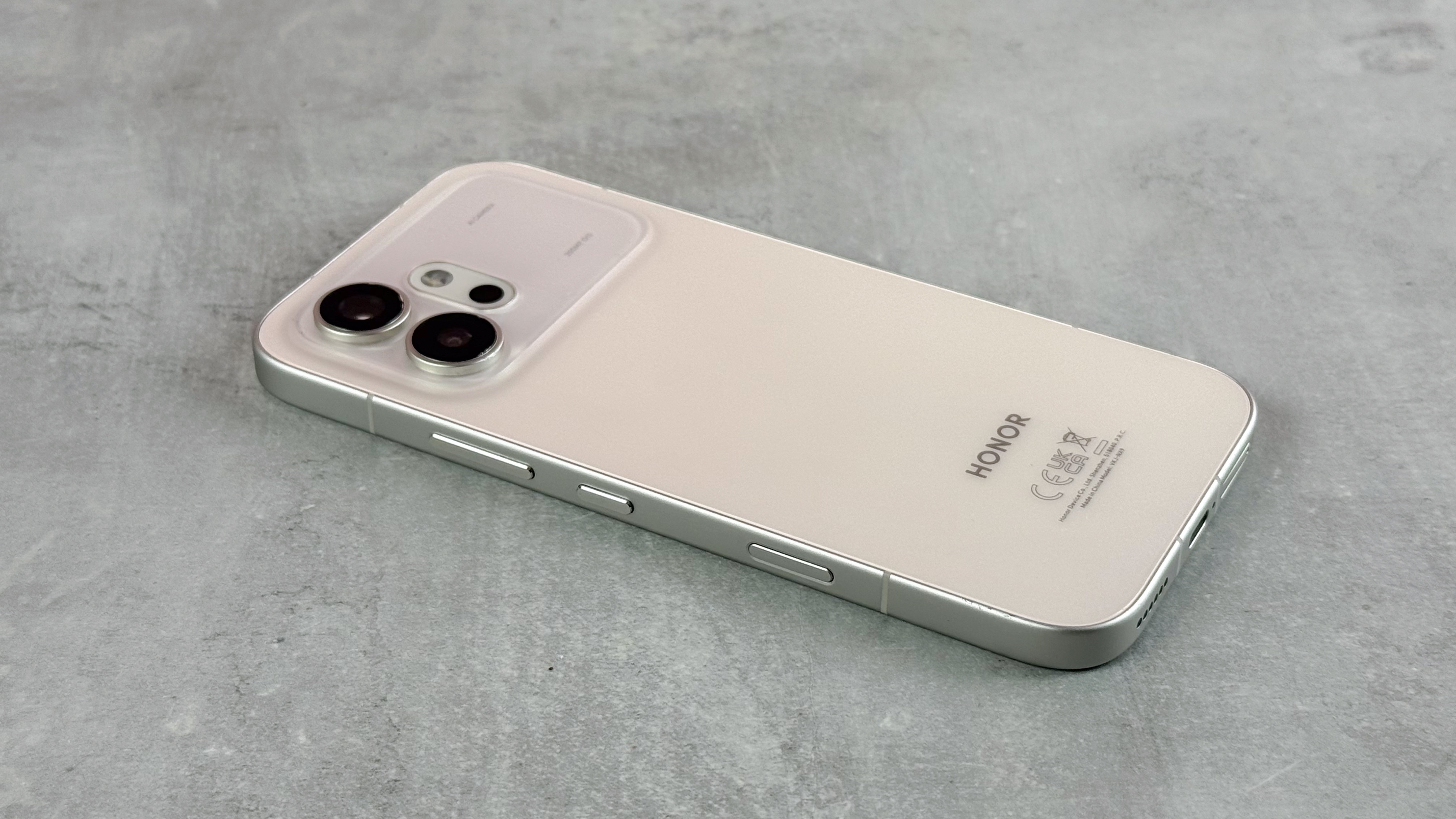 The Honor 600 laying screen down at a slight angle on a gray tabletop.