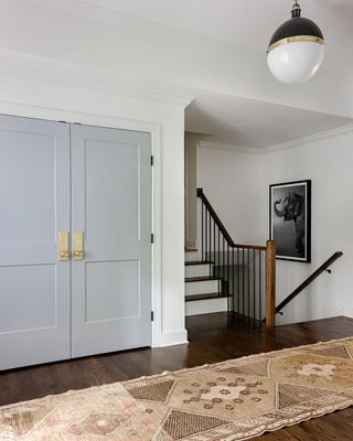 A large open entryway with staircase case and storage