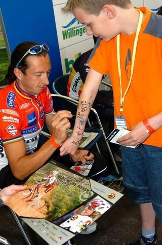 Sir Bart Brenjens signs a young fan's arm