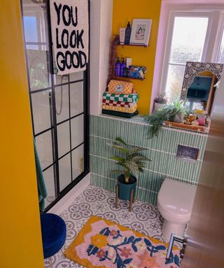 Mustard yellow bathroom with plants and accessories