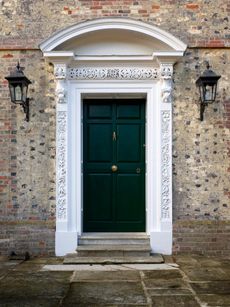 Fig 2: The doorcase decorated with foxes and an elaborate monogram, including the letters H and E bound together. ©Paul Highnam for Country Life