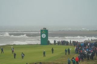 A golf course by the sea during a windy and rainy day