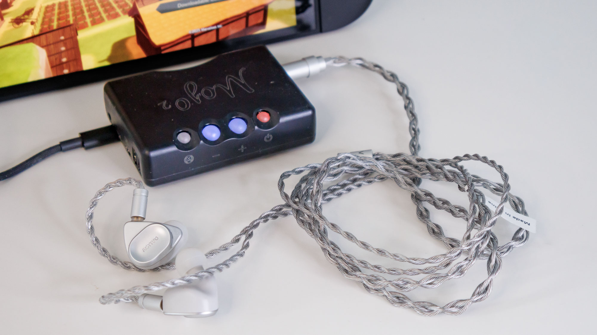 Nintendo Switch 2 next to a DAC with some headphones connected