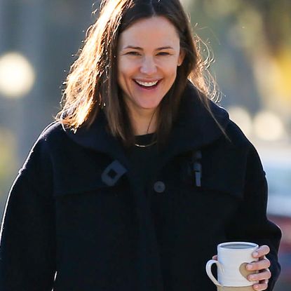 Jennifer Garner smiling and holding coffee mug