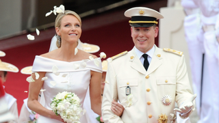 Princess Charlene of Monaco and Prince Albert Of Monaco smile as they leave the palace after the religious ceremony of the Royal Wedding of Prince Albert II of Monaco to Charlene Wittstock in the main courtyard at Prince's Palace on July 2, 2011 in Monaco