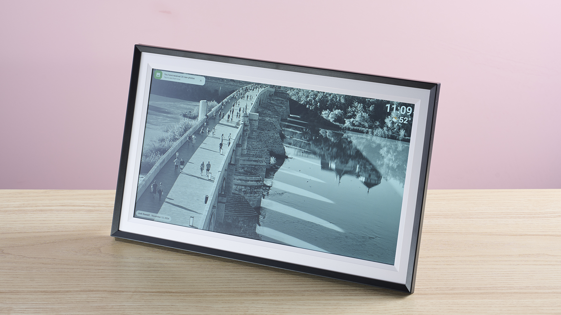 The Arzopa Digital Picture Frame WiFi 15.6-inch showing a monochrome image of the Roman Bridge of Córdoba.