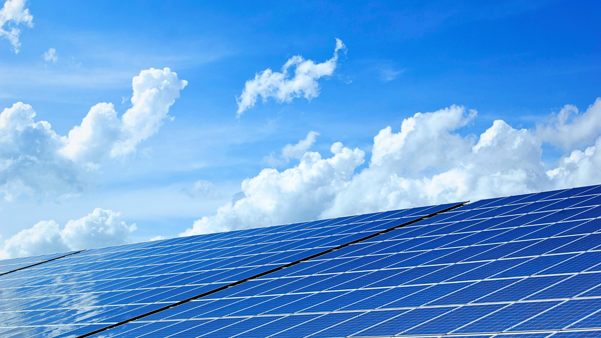 clouds behind some solar panels