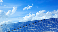 clouds behind some solar panels