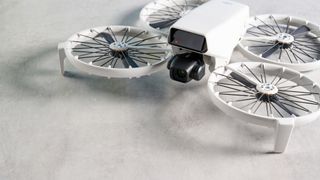 A gray DJI Flip drone with propeller guards