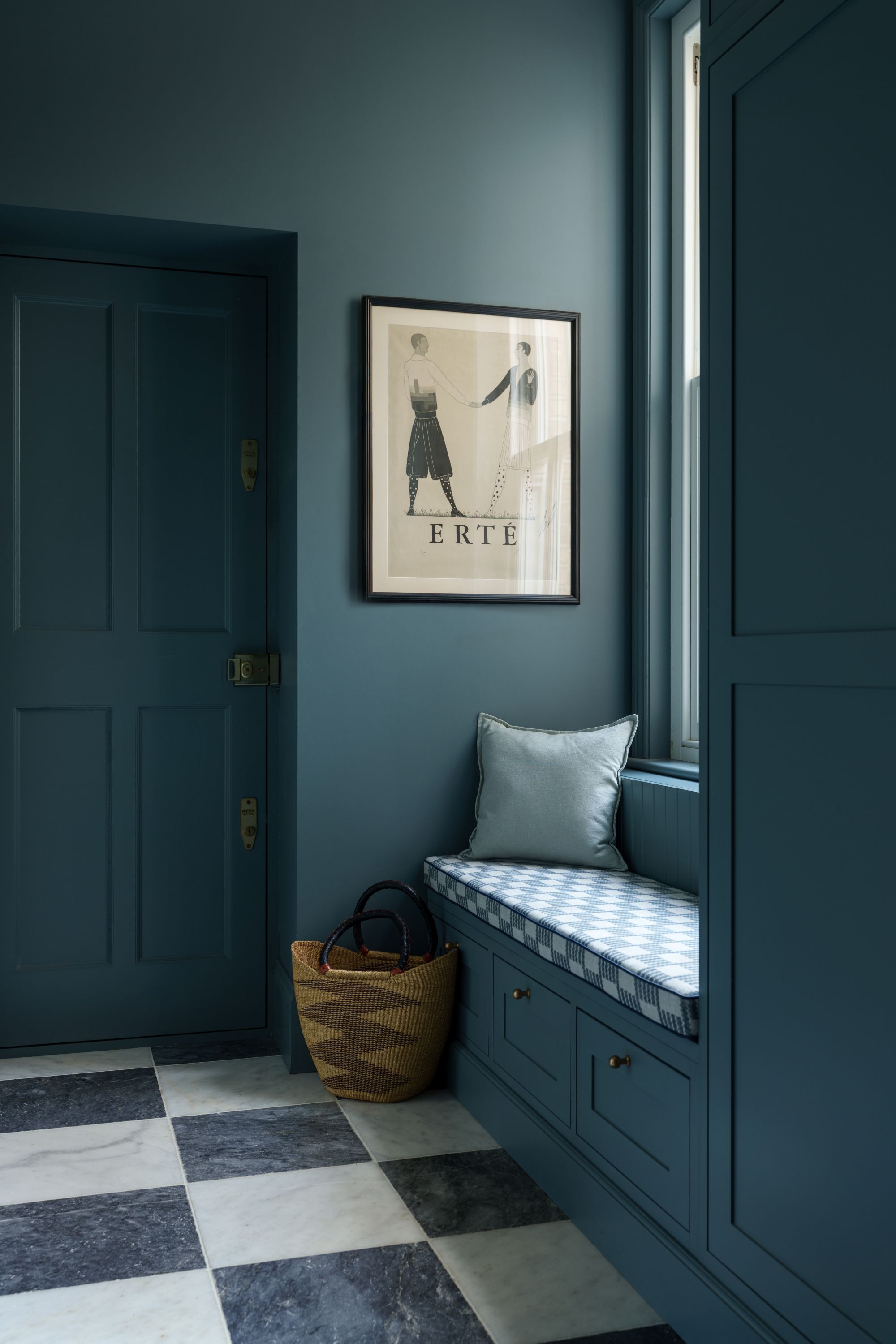 calming blue color drenched entryway with a window seat and checkerboard floors