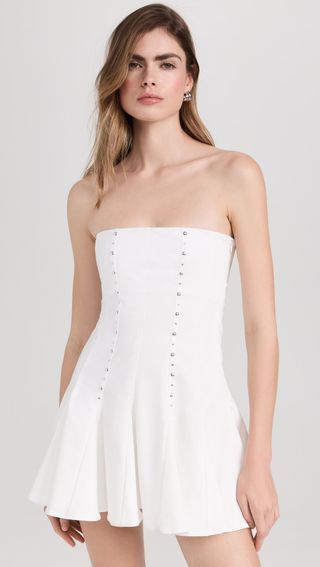 model wears short white strapless mini dress