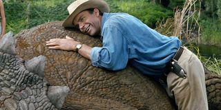 Alan Grant lies on a triceratops in Jurassic Park